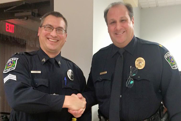 Police Sgt. Jeff Sgro (left) being recognized by Chief John Phoennik.